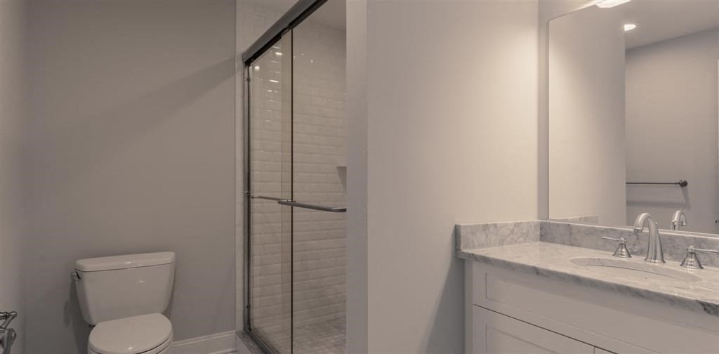 a bathroom with a toilet sink and shower at Zephyr Ridge Apartment Homes, Cedar Grove, 07009