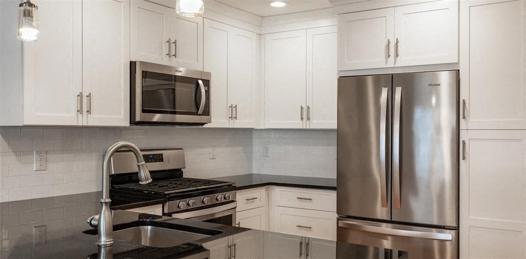 a kitchen with a stove a sink and a refrigerator at Zephyr Ridge Apartment Homes, New Jersey, 07009