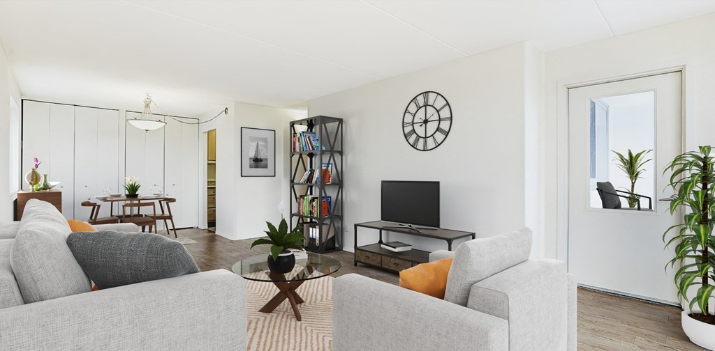 a living room with white walls and a glass coffee table at The Ivanhoe Apartments, Hackensack, NJ