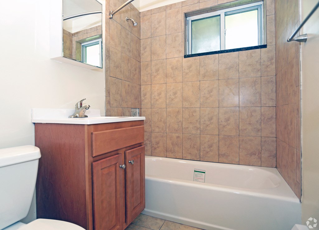 a bathroom with a toilet sink and bathtub at Willow Gardens Apartments, New Jersey