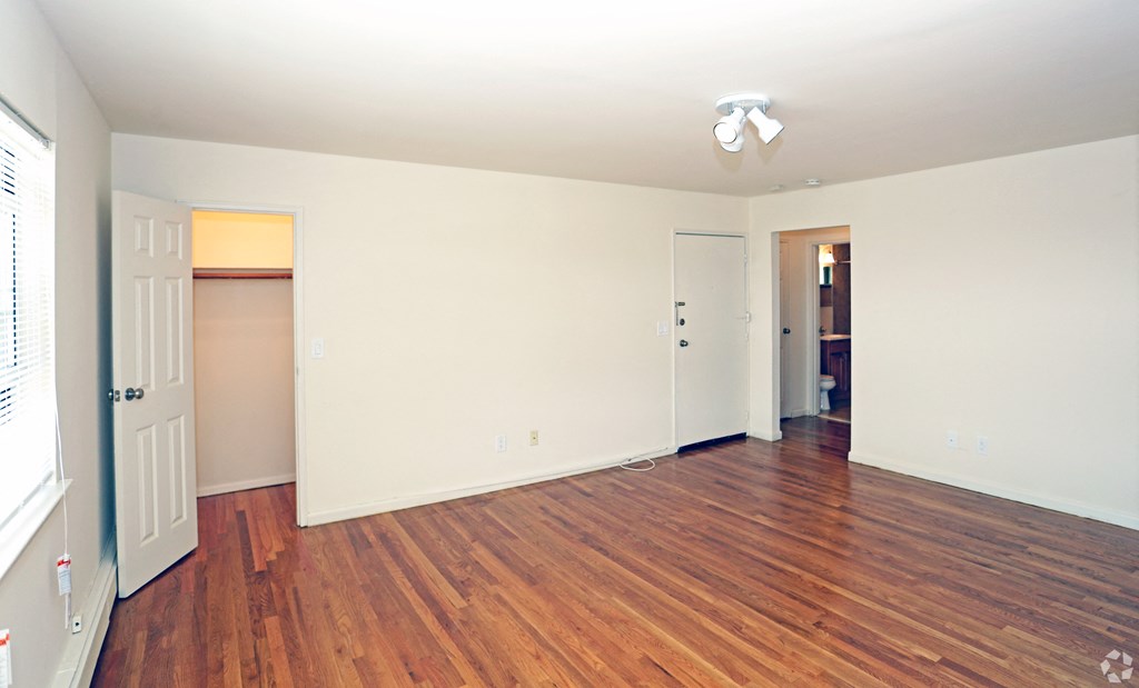 a bedroom with hardwood floors and white walls at Willow Gardens Apartments, Teaneck, New Jersey