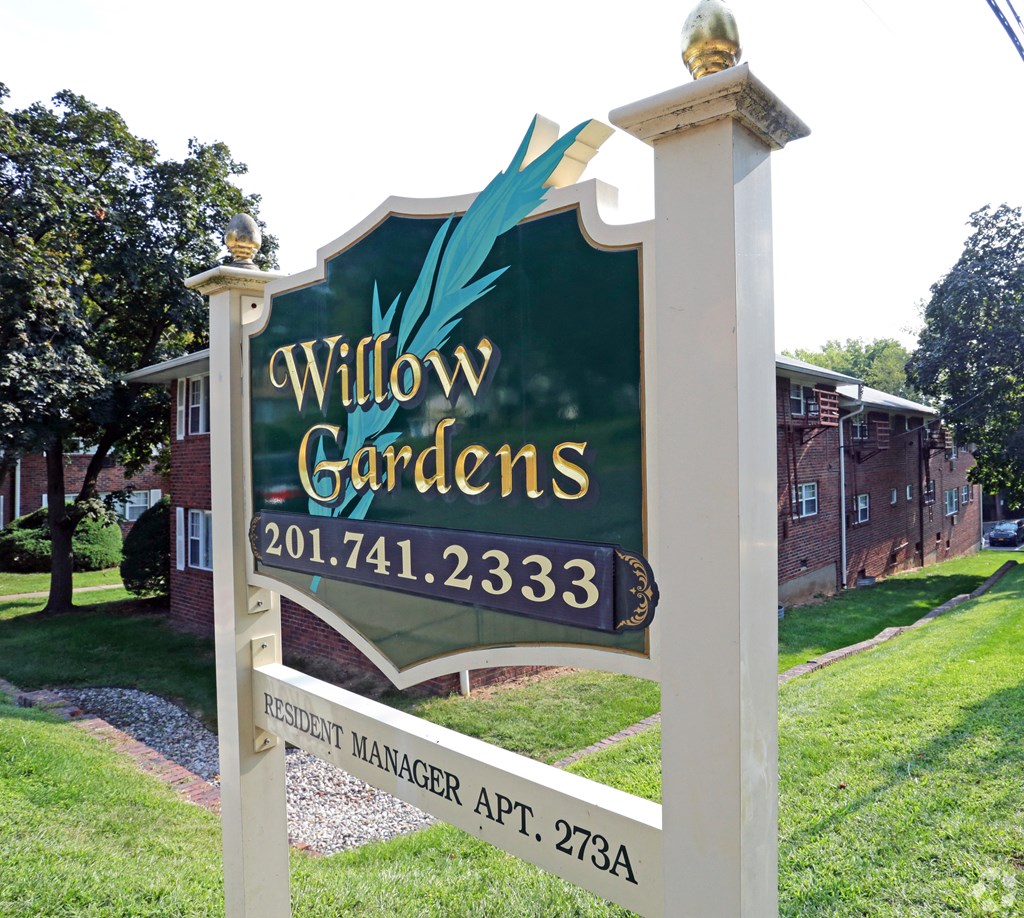 a sign in front of a building at Willow Gardens Apartments, New Jersey, 07666