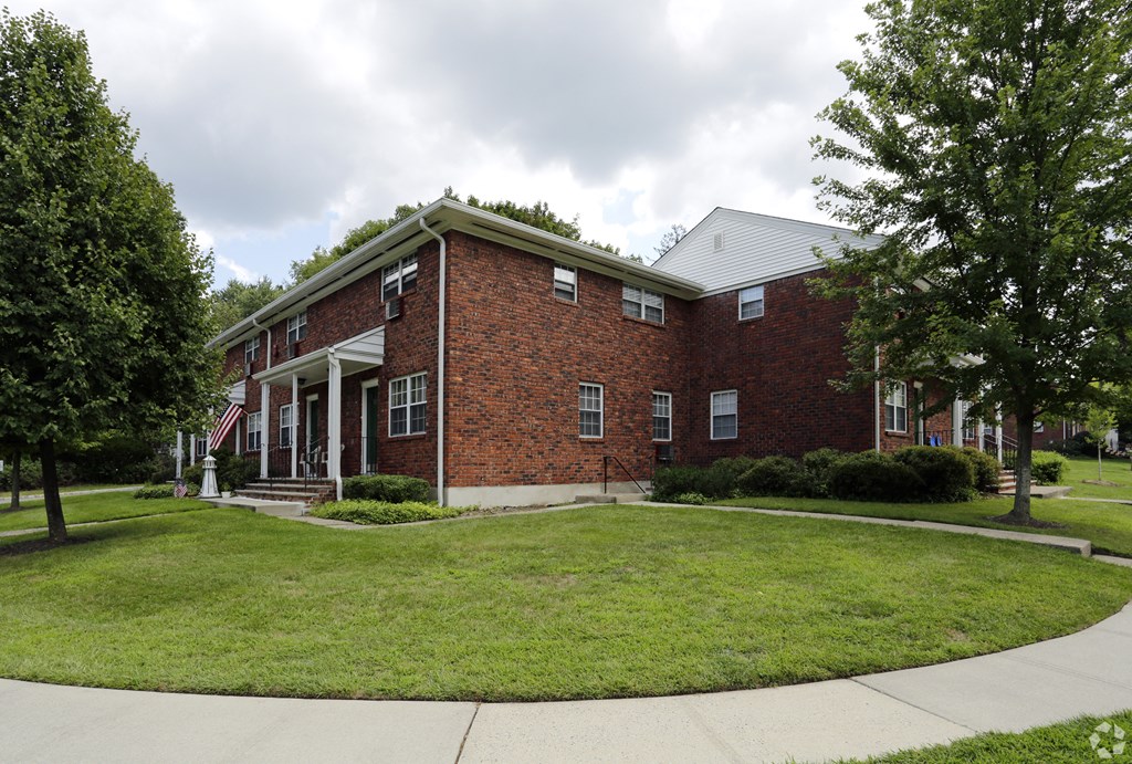 a large brick building with a green lawn in front of it at Nottingham Manor Apartments, Montvale, 07645