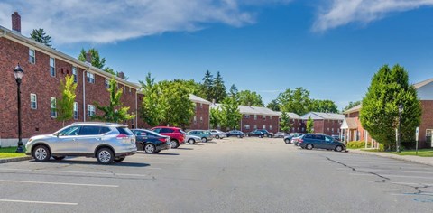 a parking lot in front of a brick building at Nottingham Manor Apartments, New Jersey, 07645