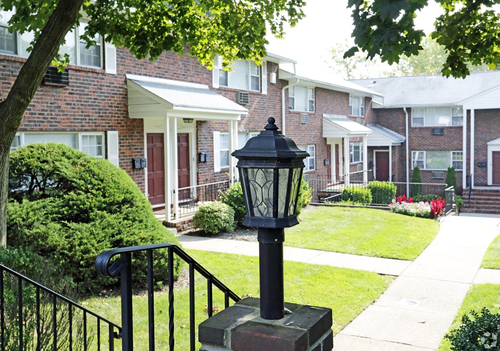 a lamp post in front of a brick buildingat Willow Gardens Apartments, New Jersey, 07666