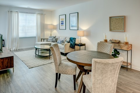 A dining room with a table and chairs.