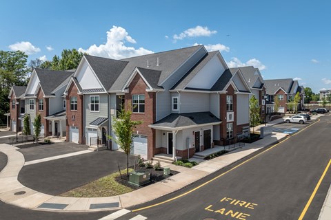 A street view of a residential area with houses and a fire lane.