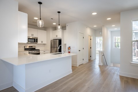 A modern kitchen with white cabinets and a large island.