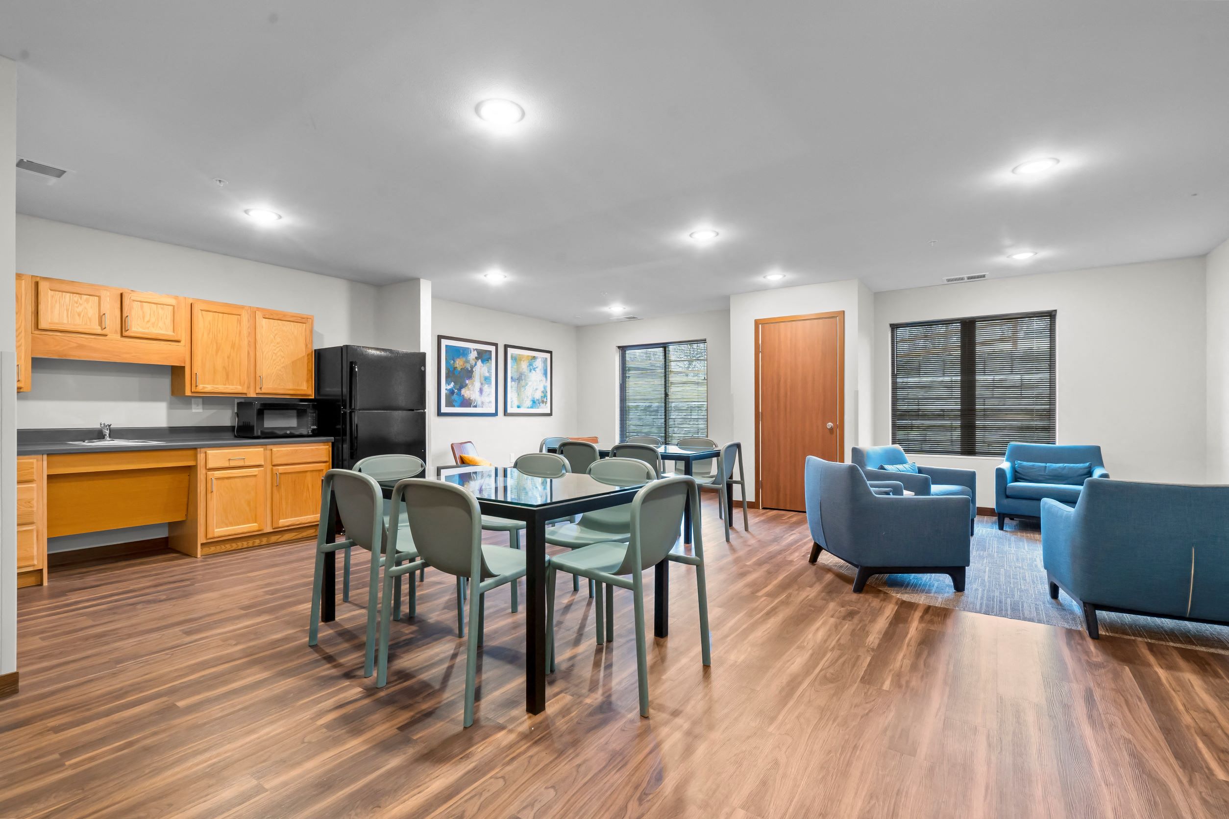 A kitchen with a dining table and chairs.