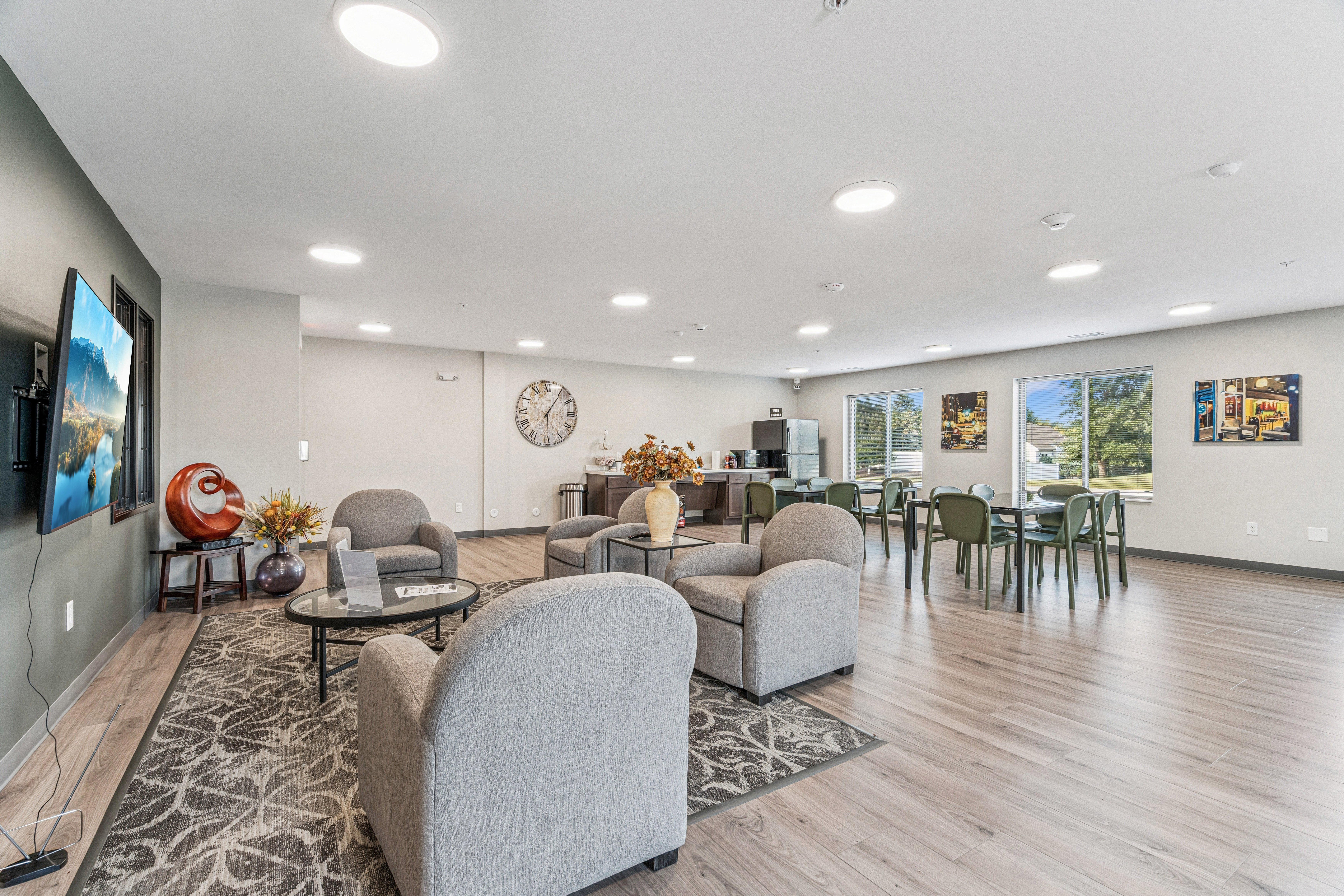 A living room with a grey sofa and a wooden floor.