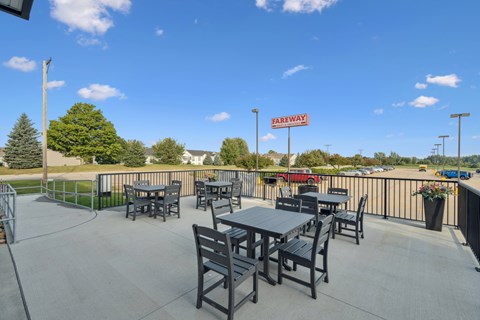 A patio with tables and chairs is set up for outdoor dining.