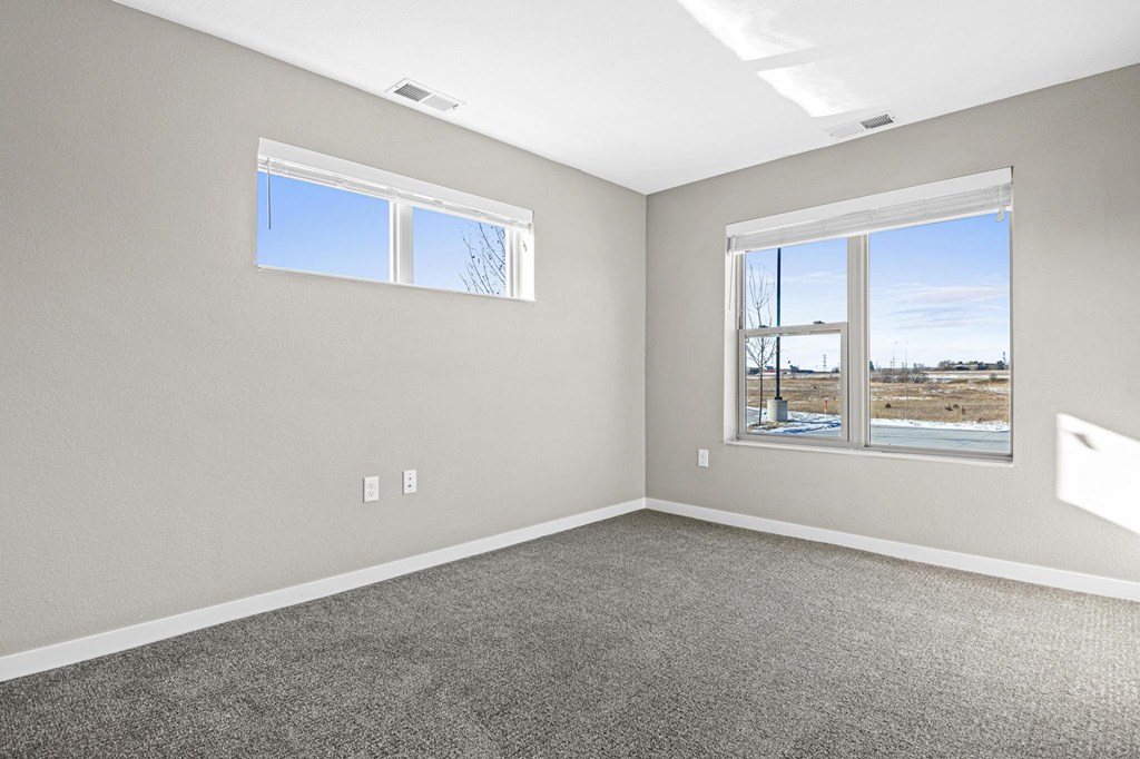 an empty room with carpet and a window