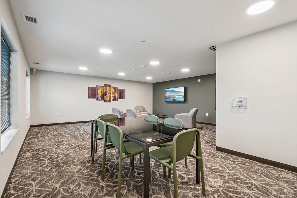 A conference room with a table and chairs.