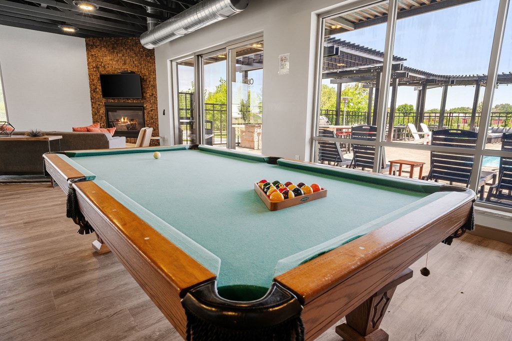 a pool table in the resident clubhouse at TRIO @ Southbridge apartments