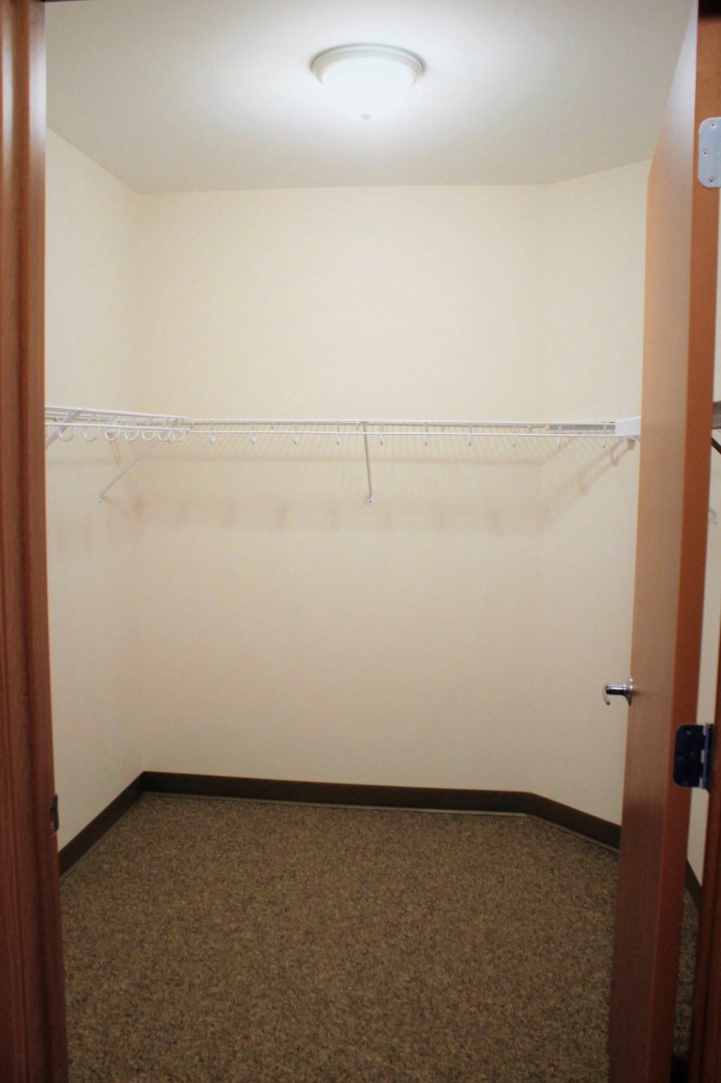 A white wall with a coat hanger.