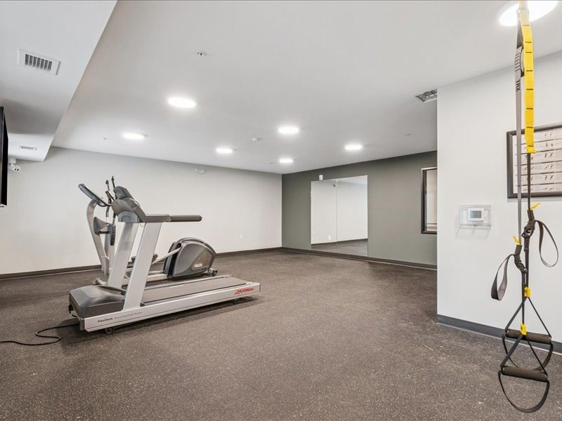 A gym with a treadmill and a rope.