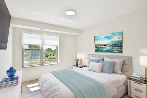 A bedroom with a large bed and a painting on the wall.