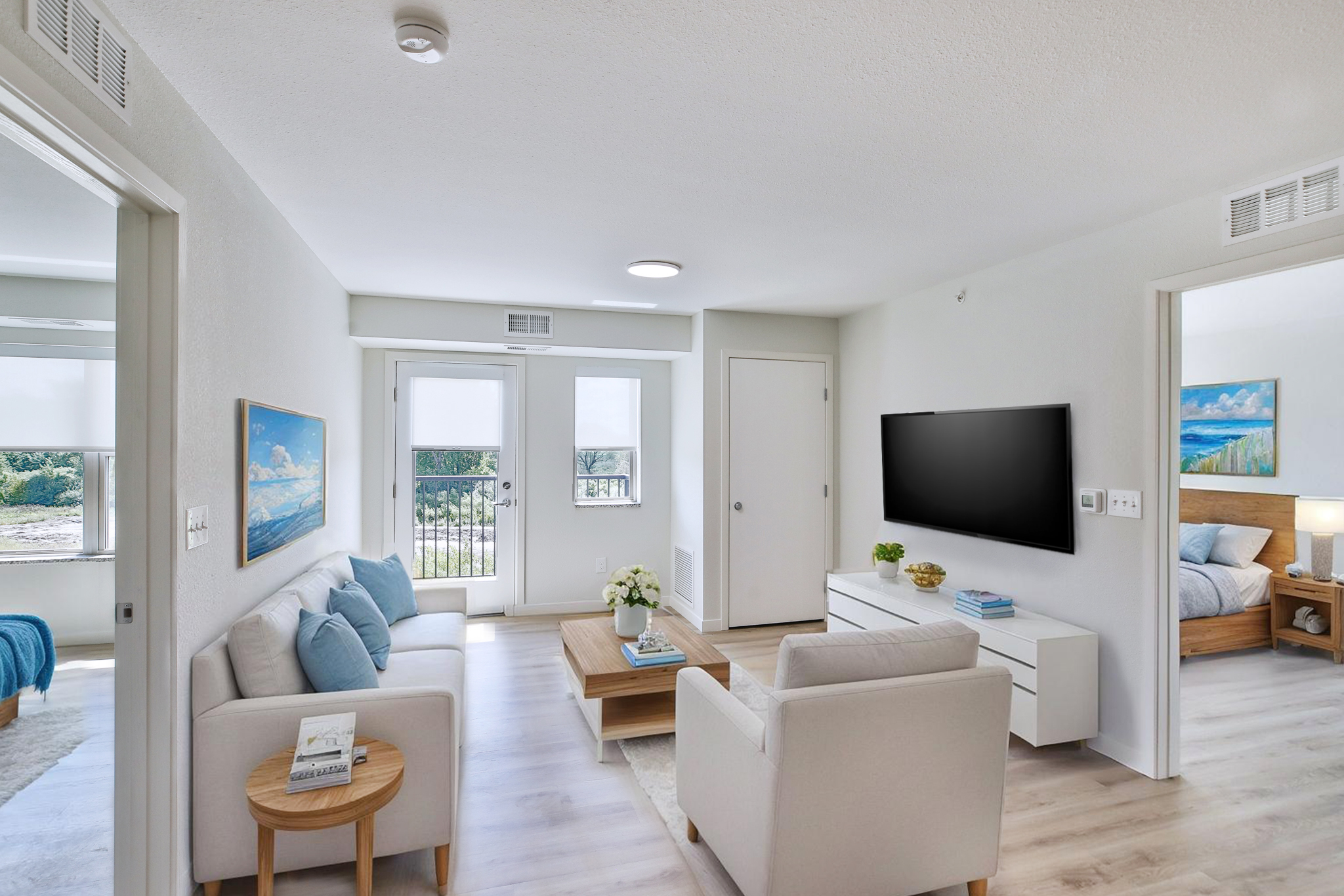 A living room with a television, couch, and a coffee table.