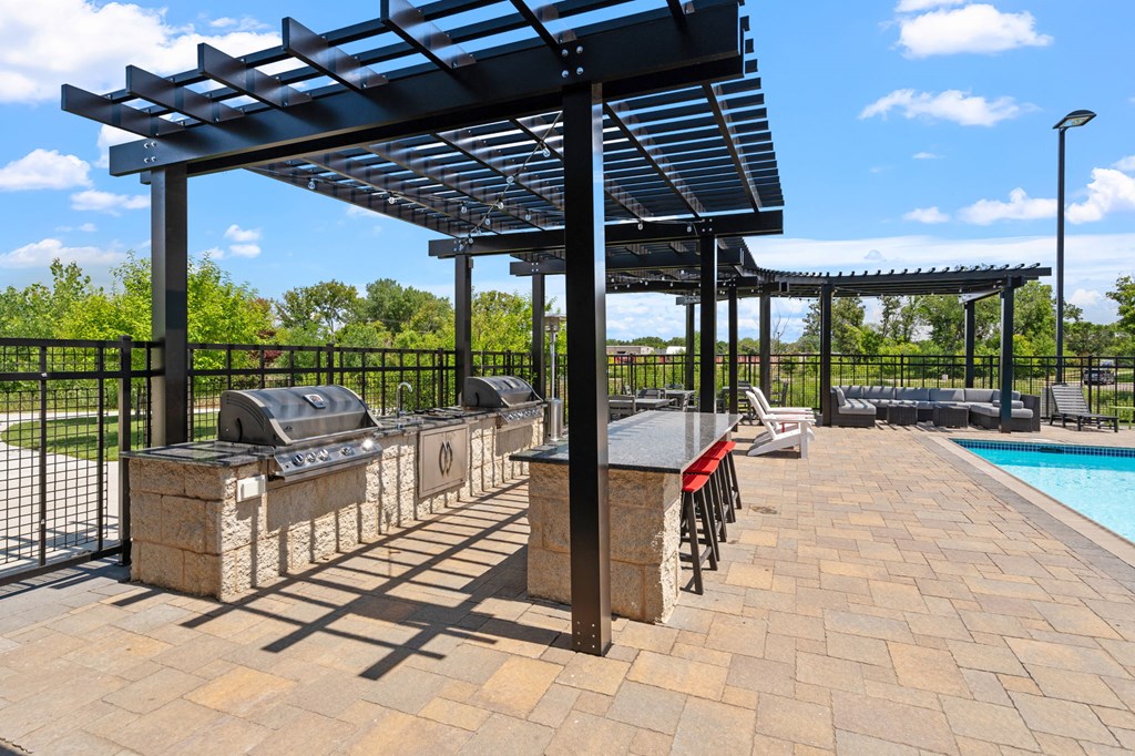 grilling stations in the outdoor pool area at TRIO @ Southbridge apartments