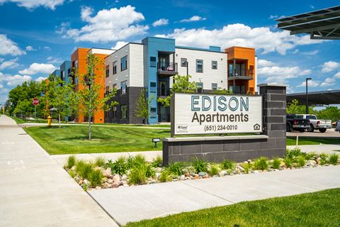 a rendering of the apartments sign in front of the building