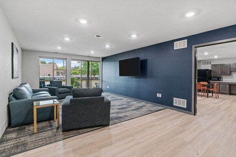 a living room with blue walls and a tv on the wall