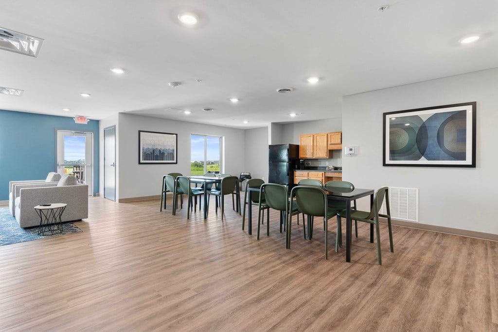a dining room and living room with a table and chairs
