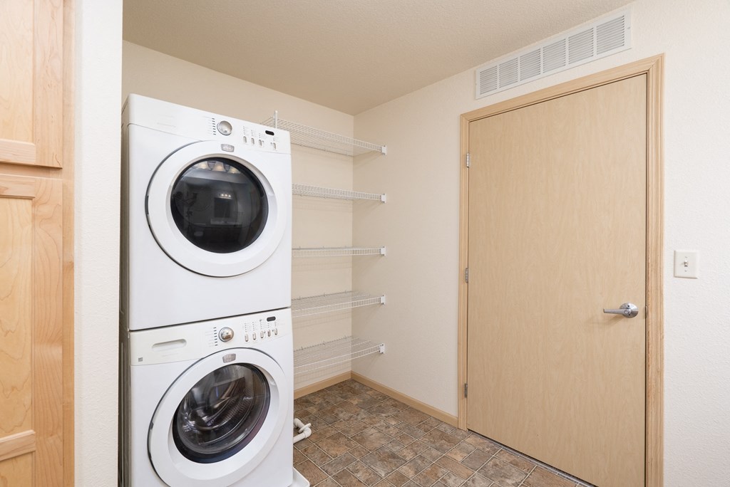a washer and dryer in a laundry room next to a closet