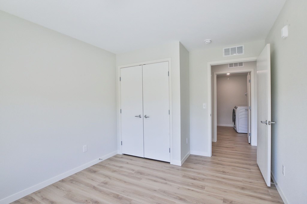 A room with a white door and a white cabinet.