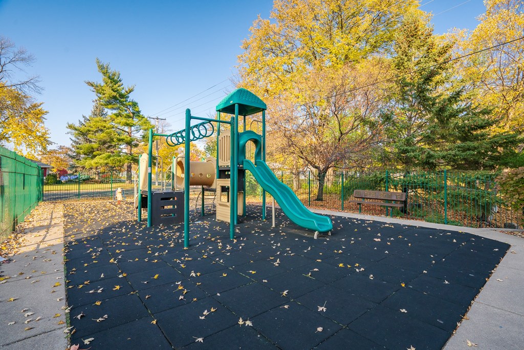 A playground with a green slide