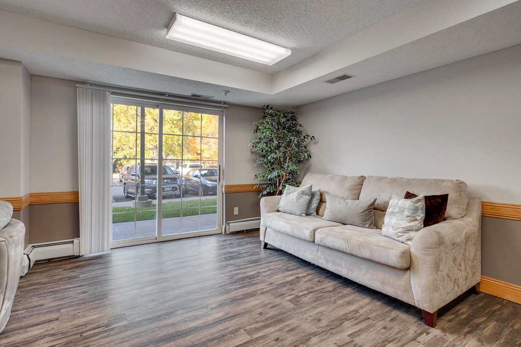a living room with a couch and a sliding glass door