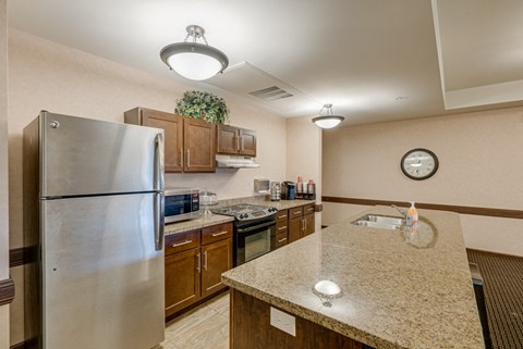 a kitchen with stainless steel appliances and granite counter tops
