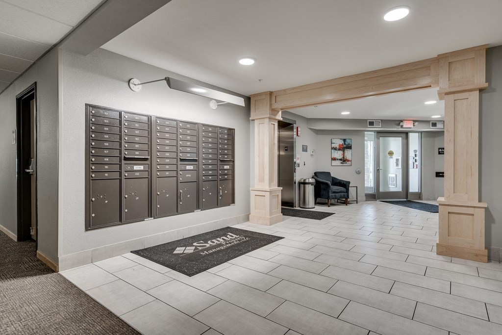 a locker room in a building with pillars and a rug