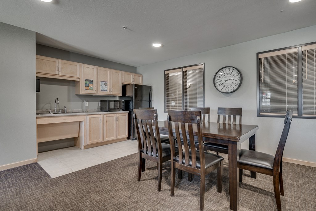 a kitchen and dining area with a wooden table and chairs
