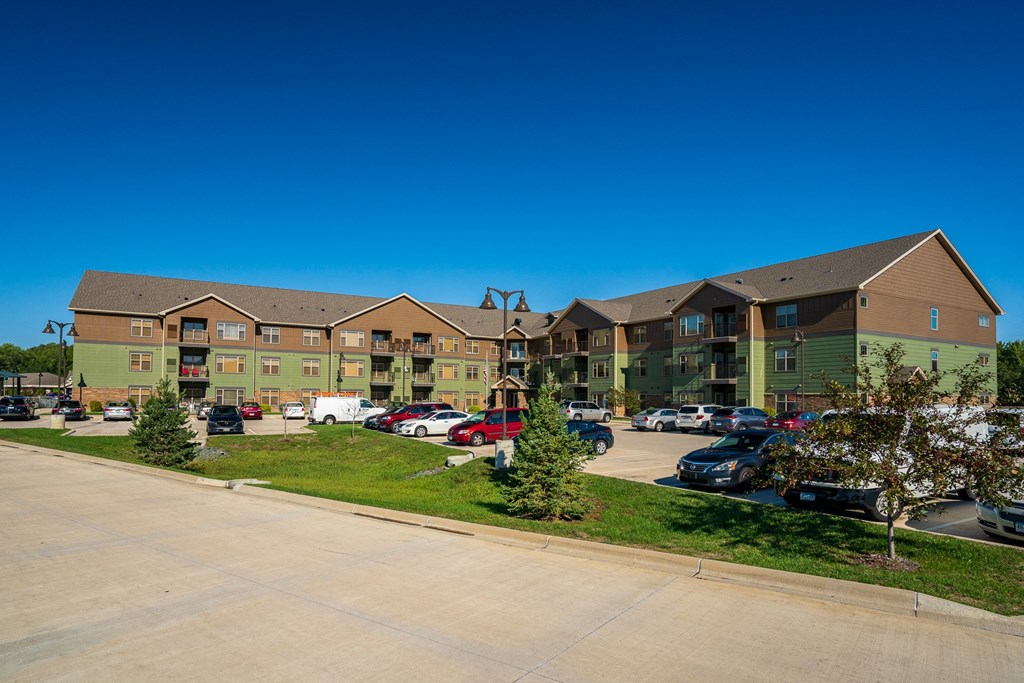 an apartment building with cars parked in front of it
