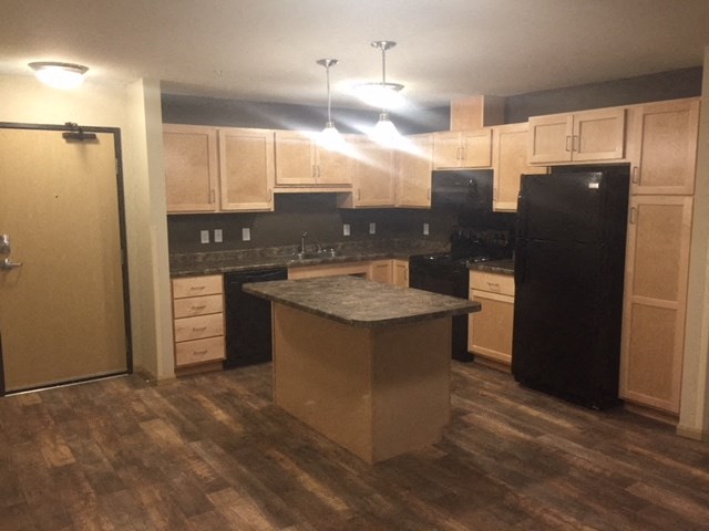 a kitchen with an island in the middle of it