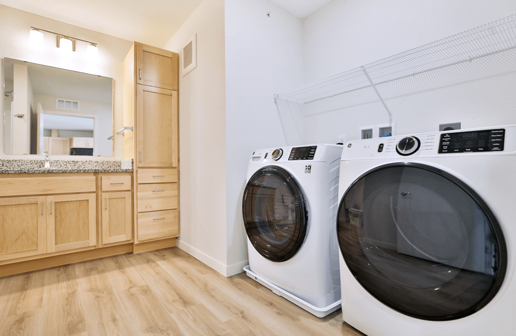 A laundry room with two front loading washing machines.