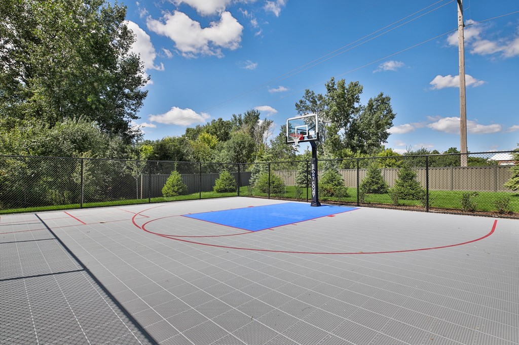 A basketball court with a blue circle in the middle.