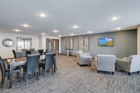 a living room with a dining room table and chairs