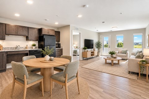 A modern kitchen with a dining table set in the middle.