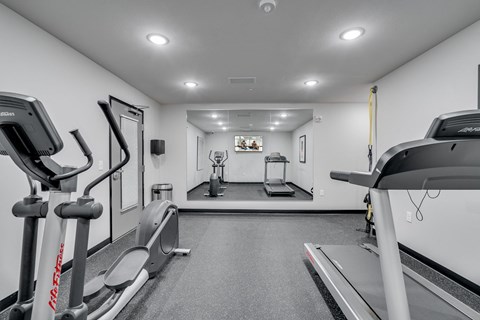 the gym is equipped with treadmills and other fitness equipment