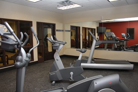 A gym with treadmills and elliptical machines.