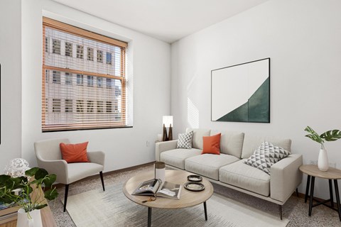 A living room with a couch, chair, and a painting on the wall.