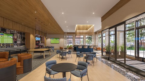 A modern lounge area with a variety of seating options and a large screen on the wall.