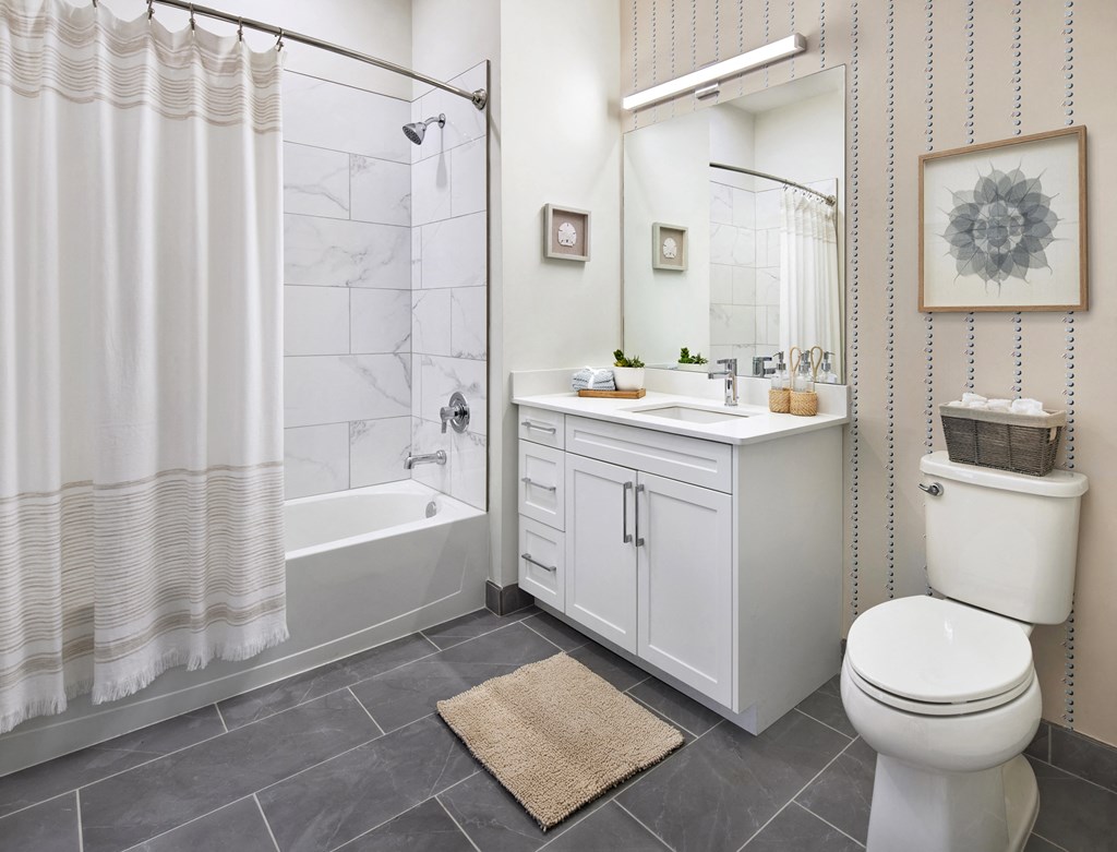 a bathroom with a shower toilet and sink
