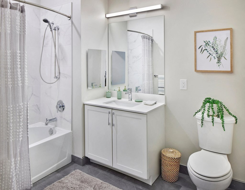 a bathroom with a toilet sink and shower