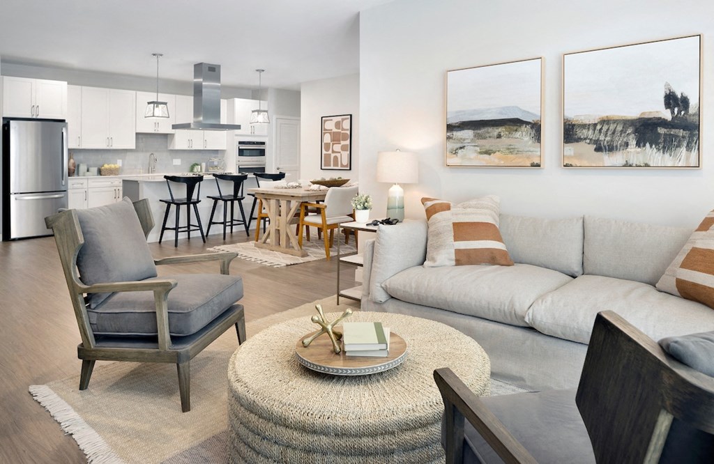 a living room with a couch chairs and a table