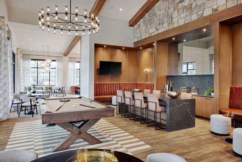 a large room with a pool table and a bar