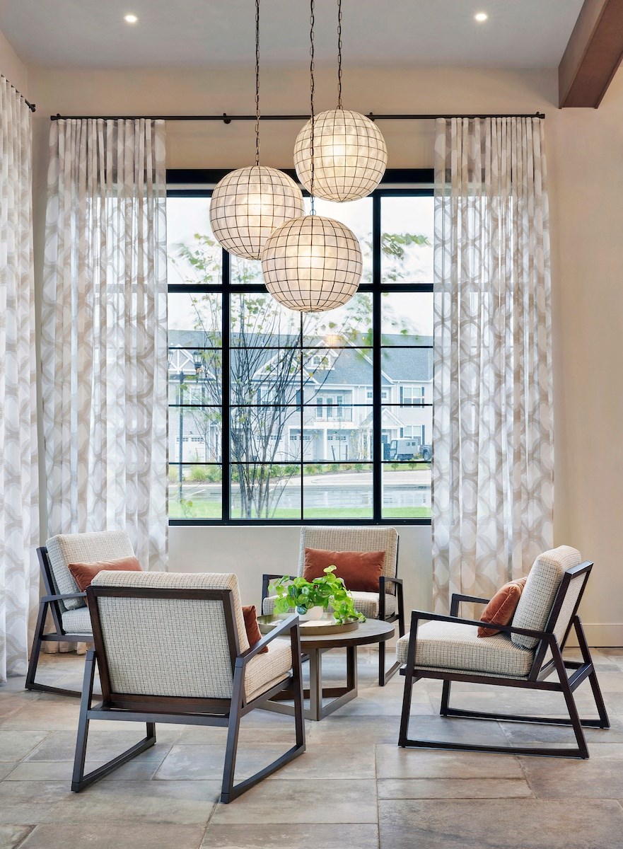 a living room filled with furniture and a large window