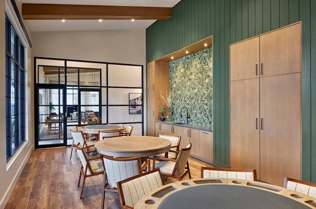 a restaurant with green walls and wooden tables and chairs