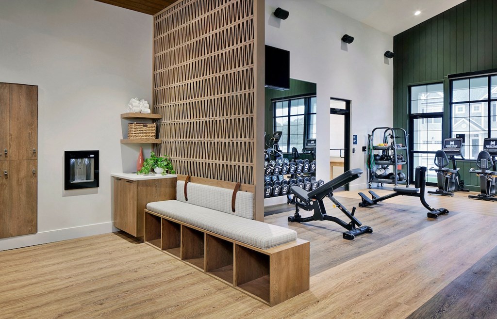 a gym with a wooden wall and bench